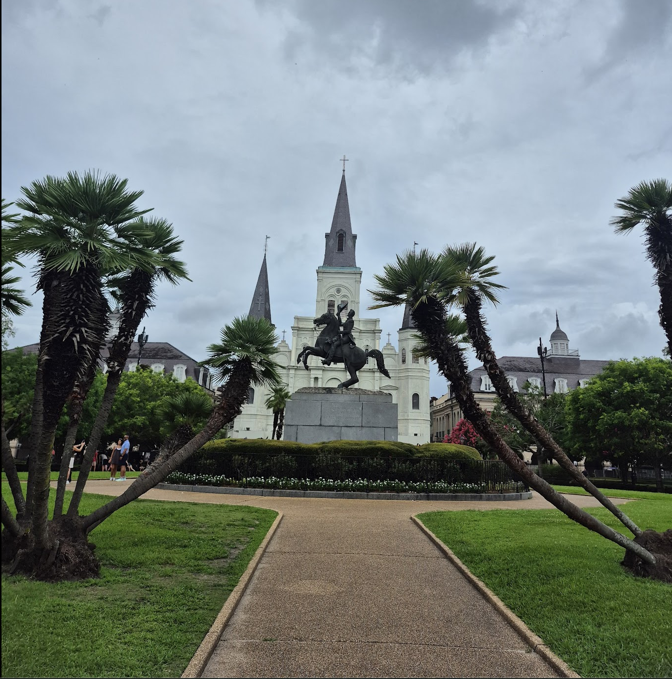 St. Louis Cathedral framed by palm trees, with the equestrian statue of Andrew Jackson in front, seen from Jackson Square in the New Orleans French Quarter